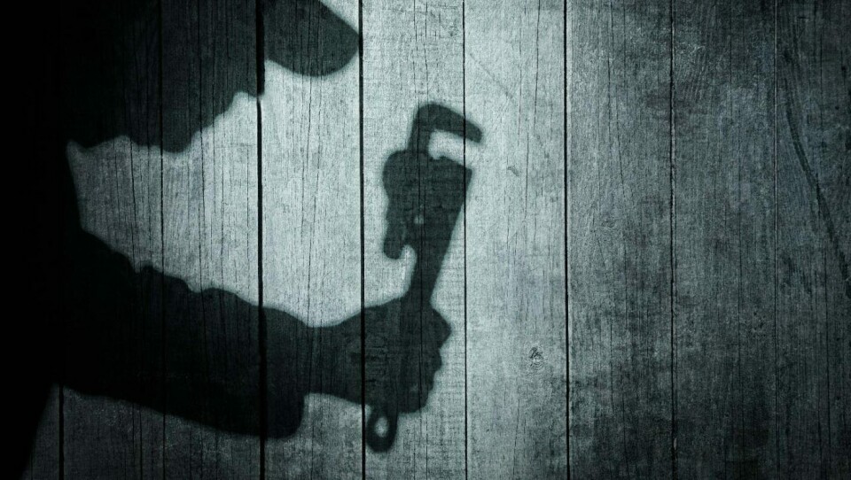 Shadow of a man with wrench in hand on natural wooden background. You can see more silhouettes and shadows on my page.Illustrasjonsfoto: Shutterstock